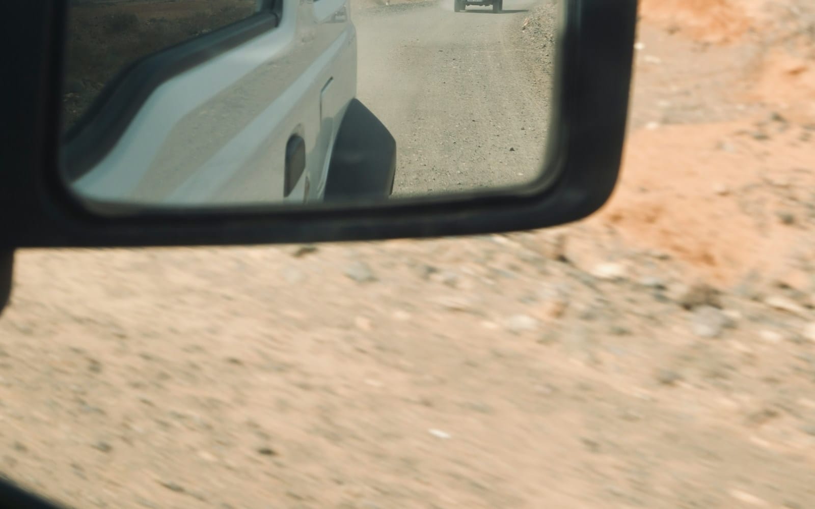 Crew vehicles on a dusty access road — mobilisation day for a remote Australian site